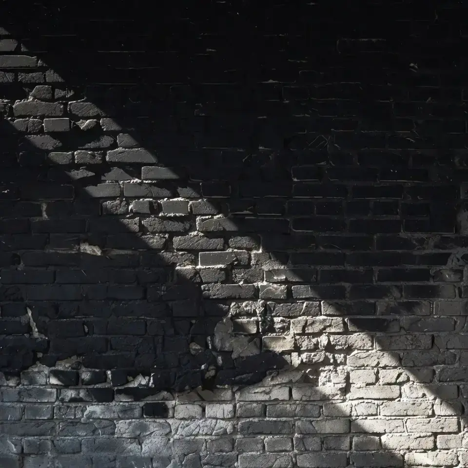Heritage brick wall, soot-black to clean