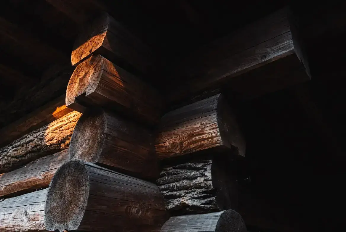 Log home corner stripped of failed stain