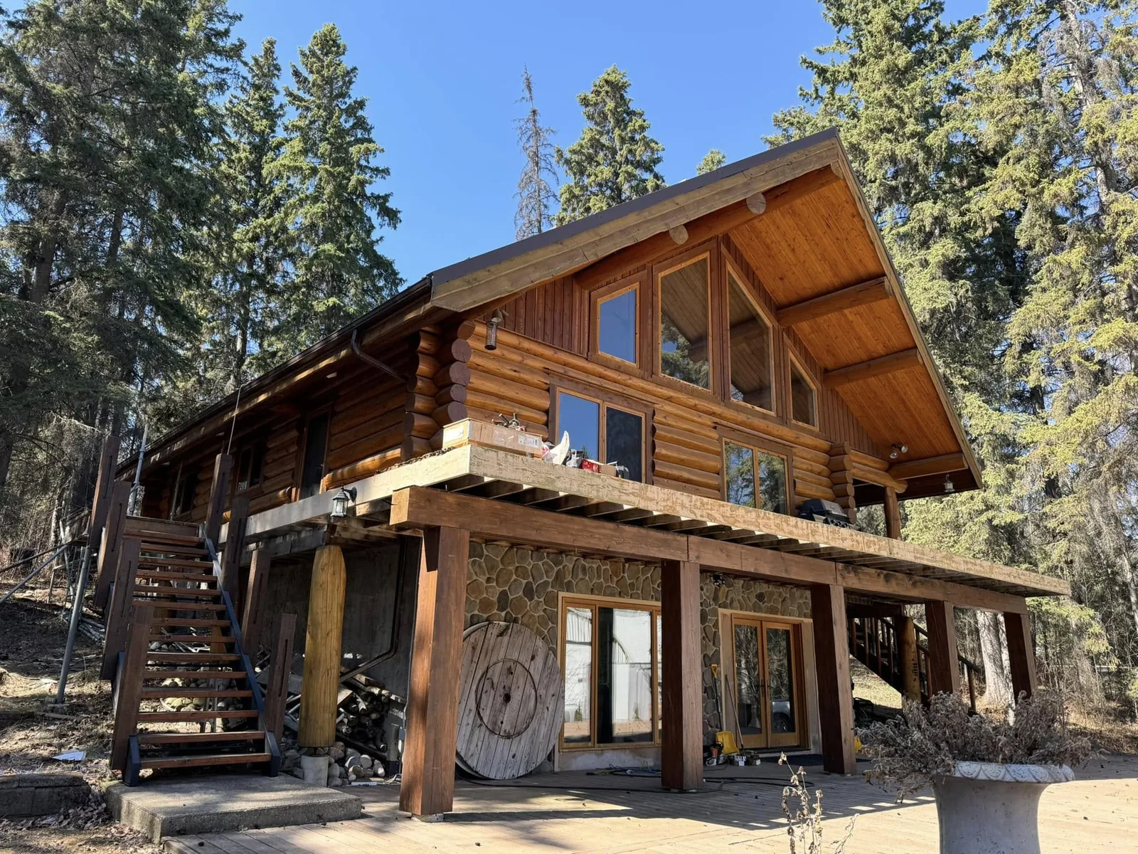 The completed log home — stained, sealed and glowing among the trees